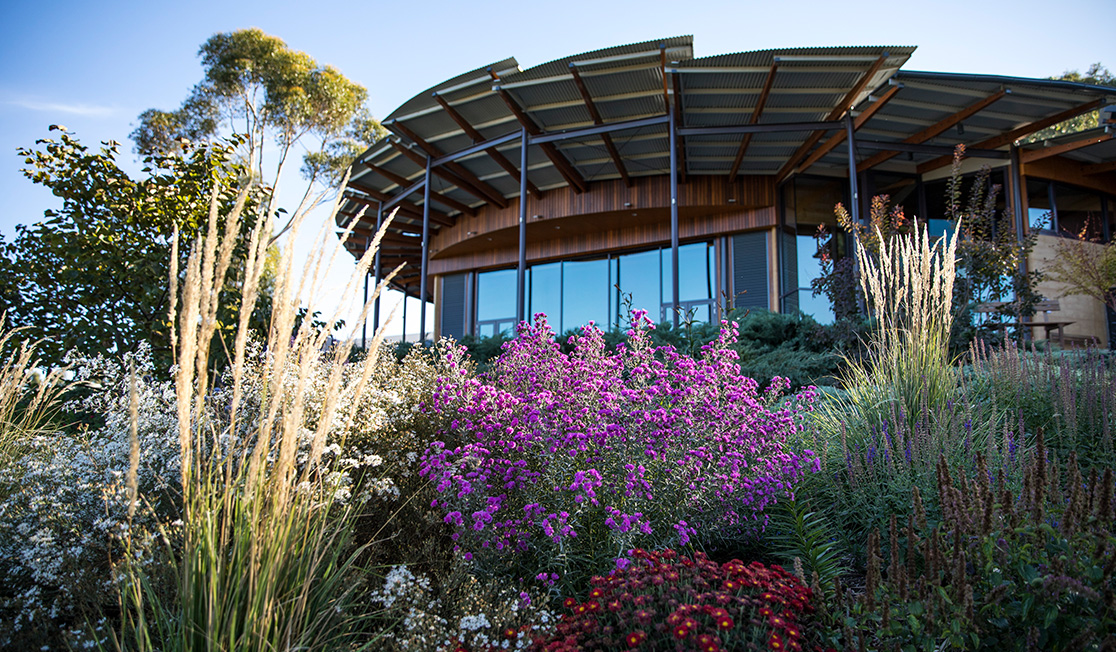 A photo of UKARIA Cultural Centre and the beautiful surrounding garden on a sunny day.